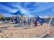 Community playground with play structures and shaded area for children at 4571 N Arbor Way, Buckeye, AZ 85396