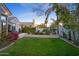 Landscaped backyard with grassy area and flowering bushes at 5403 E Cannon Dr, Paradise Valley, AZ 85253