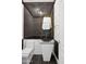 Chic powder room featuring designer mirror, black sink, and stylish accents at 5403 E Cannon Dr, Paradise Valley, AZ 85253