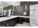 Sleek bathroom with dual vanities, custom mirrors, black backsplash and modern fixtures at 5403 E Cannon Dr, Paradise Valley, AZ 85253