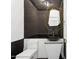 Powder room showcasing a unique gold mirror and black vessel sink at 5403 E Cannon Dr, Paradise Valley, AZ 85253