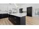 Modern kitchen with contrasting cabinetry, quartz countertops, and stainless steel appliances offers a sleek design at 5403 E Cannon Dr, Paradise Valley, AZ 85253