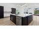 Spacious kitchen island featuring a white marble countertop, black cabinetry, and stainless steel appliances at 5403 E Cannon Dr, Paradise Valley, AZ 85253