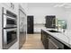 Modern kitchen with stainless steel appliances and gold fixtures offers a contemporary look at 5403 E Cannon Dr, Paradise Valley, AZ 85253