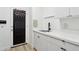 Laundry room with black board and white cabinets at 5403 E Cannon Dr, Paradise Valley, AZ 85253