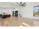 Open living room boasts bright natural light, wood tile flooring and modern lighting fixtures at 5403 E Cannon Dr, Paradise Valley, AZ 85253