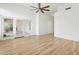 Spacious living room showcasing wood-look flooring, leading to glass doors opening to a patio or balcony at 5403 E Cannon Dr, Paradise Valley, AZ 85253