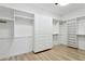 Large walk-in closet featuring custom built-in shelves, drawers and cabinetry for optimal organization and storage at 5403 E Cannon Dr, Paradise Valley, AZ 85253