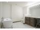 Bright bathroom featuring a claw foot tub, vanity with hollywood mirror, and marble floors and countertops at 5620 E Ocotillo Rd, Cave Creek, AZ 85331