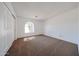 Bright bedroom with neutral carpet, a unique arched window, and closet at 7808 W Mescal St, Peoria, AZ 85345