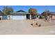 Home with desert landscaping, including rocks and greenery, a gray roof, and a two-car garage at 7808 W Mescal St, Peoria, AZ 85345