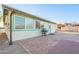 Light teal house exterior with brick patio and gas grill at 867 N Arroya Rd, Apache Junction, AZ 85119