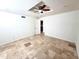 Bedroom with a ceiling fan and light, tile floors, base molding and a view of the kitchen at 867 N Arroya Rd, Apache Junction, AZ 85119