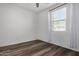 Spacious bedroom with wood-look floors and window at 9317 E Static Ave, Mesa, AZ 85212