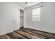 Simple bedroom with wood-look floors and closet at 9317 E Static Ave, Mesa, AZ 85212