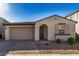 Single-story home with a two-car garage and desert landscaping at 9317 E Static Ave, Mesa, AZ 85212