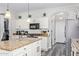 Kitchen features granite island, white cabinets, and stainless steel appliances at 941 W Dexter Way, San Tan Valley, AZ 85143