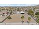 Expansive property features a custom home, large dirt lot, and mature landscaping at 9437 W Avenida Del Sol Ave, Peoria, AZ 85383