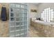 Bright bathroom with glass block wall and standalone tub at 9437 W Avenida Del Sol Ave, Peoria, AZ 85383