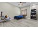 Bedroom features wood floors, ceiling fan, and window with wooden shutters at 9437 W Avenida Del Sol Ave, Peoria, AZ 85383