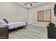 Bedroom features wood floors, ceiling fan, and window with wooden shutters at 9437 W Avenida Del Sol Ave, Peoria, AZ 85383