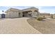 Spacious single-story house featuring a circular driveway, drought-resistant landscaping, and a gated entrance at 9437 W Avenida Del Sol Ave, Peoria, AZ 85383