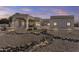 Stunning home exterior with desert landscaping, fountain, and porte cochere at 9437 W Avenida Del Sol Ave, Peoria, AZ 85383