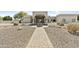 Attractive home exterior featuring desert landscaping, pavers, and a water fountain at 9437 W Avenida Del Sol Ave, Peoria, AZ 85383