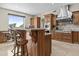 Gourmet kitchen with island, stainless steel hood vent, and custom cabinets at 9437 W Avenida Del Sol Ave, Peoria, AZ 85383