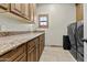 Laundry room with washer, dryer, wooden cabinets and granite counters at 9437 W Avenida Del Sol Ave, Peoria, AZ 85383