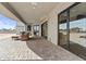 Covered patio features sleek black framed windows, stone pavers and outdoor seating area at 9437 W Avenida Del Sol Ave, Peoria, AZ 85383