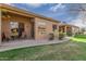 Private backyard patio with grassy area and mature landscaping at 9610 E Rocky Lake Dr, Sun Lakes, AZ 85248
