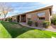 Private backyard patio with grassy area and mature landscaping at 9610 E Rocky Lake Dr, Sun Lakes, AZ 85248