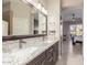Bathroom with double sinks, granite vanity, and large mirror at 9610 E Rocky Lake Dr, Sun Lakes, AZ 85248