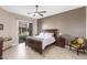 Bedroom with dark wood furniture and access to backyard at 9610 E Rocky Lake Dr, Sun Lakes, AZ 85248