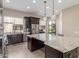 Kitchen with island, granite countertops and backyard view at 9610 E Rocky Lake Dr, Sun Lakes, AZ 85248