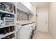 Laundry room with washer, dryer, storage cabinets and additional shelving at 9610 E Rocky Lake Dr, Sun Lakes, AZ 85248