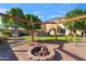 Backyard with playset, fire pit, and grassy area at 9931 W Odeum Ln, Tolleson, AZ 85353