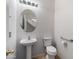 Small bathroom with pedestal sink and toilet at 9931 W Odeum Ln, Tolleson, AZ 85353