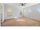 Large bedroom with carpet, ceiling fan, and window blinds at 9931 W Odeum Ln, Tolleson, AZ 85353