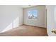 Well-lit bedroom with neutral walls and carpet at 9931 W Odeum Ln, Tolleson, AZ 85353