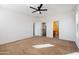 Primary bedroom with ceiling fan and ensuite bathroom at 9931 W Odeum Ln, Tolleson, AZ 85353