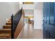 Bright and spacious entryway with staircase and view into the kitchen at 9931 W Odeum Ln, Tolleson, AZ 85353