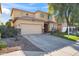 Two-story house with beige exterior, landscaping, and a two-car garage at 9931 W Odeum Ln, Tolleson, AZ 85353