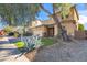 Two-story house with a beige exterior, landscaping, and a two-car garage at 9931 W Odeum Ln, Tolleson, AZ 85353