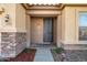 Inviting front door entrance with stone accents and landscaping at 9931 W Odeum Ln, Tolleson, AZ 85353