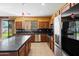 Spacious kitchen with dark countertops, stainless steel appliances, and island at 9931 W Odeum Ln, Tolleson, AZ 85353