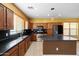 Kitchen with dark countertops, stainless steel appliances, and island at 9931 W Odeum Ln, Tolleson, AZ 85353