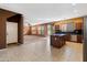 Open kitchen with island, dark countertops, and wooden cabinets at 9931 W Odeum Ln, Tolleson, AZ 85353