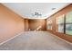 Spacious living room with neutral walls and carpet at 9931 W Odeum Ln, Tolleson, AZ 85353